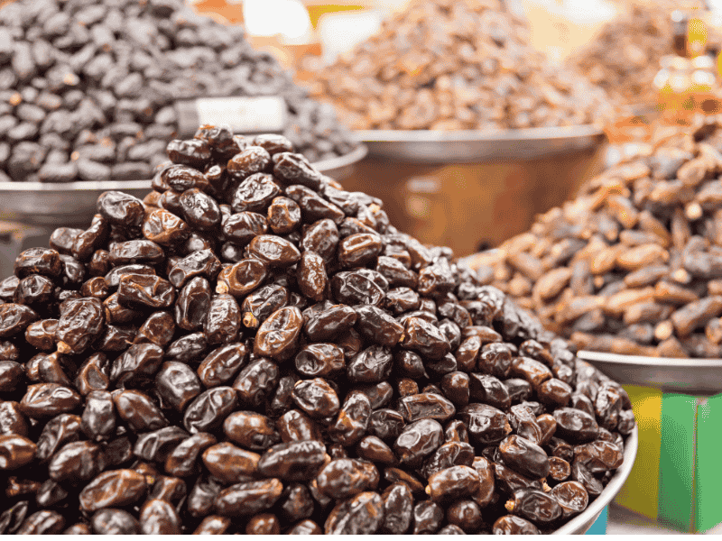 Different varieties of bulk Khajoor including Ajwa, Aseel, and Mazafati at Abdul Muqeet Traders' warehouse.